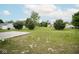 Spacious backyard featuring a large grassy area, mature trees, and a concrete patio space at 975 Red Hills Ct, Lebanon, IN 46052