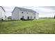 Spacious backyard featuring a patio set, grassy lawn, and a two-story home's exterior at 975 Red Hills Ct, Lebanon, IN 46052