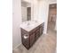 Bright bathroom featuring a double sink vanity with dark wood cabinets and a neutral tile floor at 975 Red Hills Ct, Lebanon, IN 46052
