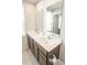 Bathroom featuring double sink vanity with dark wood cabinets, large mirrors, and updated fixtures at 975 Red Hills Ct, Lebanon, IN 46052