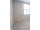 Bright bedroom features a large window, neutral walls and carpet, offering a serene retreat at 975 Red Hills Ct, Lebanon, IN 46052