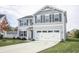 Beautiful two-story home boasting a spacious driveway and a well-kept lawn at 975 Red Hills Ct, Lebanon, IN 46052