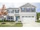 Traditional two-story home featuring gray siding, black shutters, and a well-maintained front yard at 975 Red Hills Ct, Lebanon, IN 46052