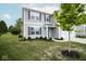 Two-story home showcasing gray siding, dark shutters, an attached garage, and a well-manicured lawn at 975 Red Hills Ct, Lebanon, IN 46052