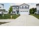 Traditional two-story home featuring gray siding, dark shutters, an attached garage, and a concrete driveway at 975 Red Hills Ct, Lebanon, IN 46052