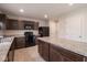 Functional kitchen with dark cabinetry, modern appliances, central island, and tile flooring under recessed lighting at 975 Red Hills Ct, Lebanon, IN 46052