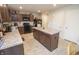 Charming kitchen with a kitchen island featuring a stone counter, dark wood cabinets, and modern appliances at 975 Red Hills Ct, Lebanon, IN 46052