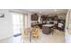 Eat-in kitchen featuring sliding glass door, wooden table and chairs, kitchen island, and ample cabinet storage at 975 Red Hills Ct, Lebanon, IN 46052