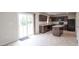 Well-lit kitchen featuring dark cabinetry, modern appliances, a center island, and sliding glass doors at 975 Red Hills Ct, Lebanon, IN 46052