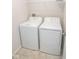 A well-lit laundry room equipped with a washer, dryer, and a convenient overhead wire shelf at 975 Red Hills Ct, Lebanon, IN 46052