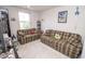 A colorful living room includes plaid couches and a window view at 975 Red Hills Ct, Lebanon, IN 46052