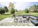 Outdoor brick patio with lounge seating, and a lush green lawn and backyard at 975 Red Hills Ct, Lebanon, IN 46052