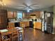 Charming kitchen with stainless steel refrigerator, wood cabinets, and adjacent eating area at 1418 Osprey Way, Greenwood, IN 46143