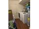 Functional laundry room features a modern washer and dryer, a storage shelf, and ample space at 1418 Osprey Way, Greenwood, IN 46143