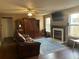 Warm and inviting living room with a brick fireplace, large windows, and comfortable seating at 1418 Osprey Way, Greenwood, IN 46143