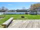 Spacious backyard features a wooden deck, bench, manicured lawn, fire pit and privacy fence at 409 Dale St, Martinsville, IN 46151