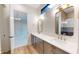 Double vanity bathroom with modern fixtures and a large mirror at 4325 Hamilton Run, Zionsville, IN 46077