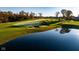 Scenic golf course view featuring lush green fairways, sand bunkers, a serene pond, and beautiful mature trees at 4325 Hamilton Run, Zionsville, IN 46077
