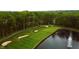 Aerial view of a golf course with a water feature and fountain near a lush green with players enjoying the course at 4325 Hamilton Run, Zionsville, IN 46077