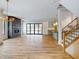 Open living room with fireplace, hardwood floors, and sliding glass doors leading to backyard at 4325 Hamilton Run, Zionsville, IN 46077