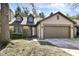 Charming home with a two-car garage, stone accents, and dormer windows at 8191 Frisco Way, Indianapolis, IN 46240