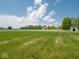 Expansive green backyard with a white fence, providing a picturesque and secure outdoor space for recreation and enjoyment at 5784 N 600 E, Greenfield, IN 46140