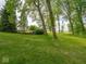 Beautiful backyard featuring a well-manicured lawn, mature trees, and serene landscaping at 5784 N 600 E, Greenfield, IN 46140