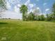 Expansive backyard with a lush lawn, mature trees, and picturesque landscaping at 5784 N 600 E, Greenfield, IN 46140