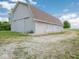 Exterior side view of the barn featuring a large structure with gravel surroundings at 5784 N 600 E, Greenfield, IN 46140