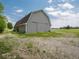 Exterior shot of the barn showcasing the sliding doors and surrounding landscape at 5784 N 600 E, Greenfield, IN 46140