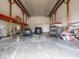 Large barn interior featuring multiple vehicles, storage space, and high ceilings with wooden beams at 5784 N 600 E, Greenfield, IN 46140
