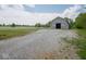 Large gray barn with open doors, providing ample storage or workspace, set against a scenic backdrop at 5784 N 600 E, Greenfield, IN 46140