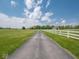 Long driveway lined with white fences leading to a barn at 5784 N 600 E, Greenfield, IN 46140