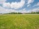 Expansive lush green field under a bright, partly cloudy sky at 5784 N 600 E, Greenfield, IN 46140