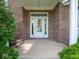 Charming brick home entrance featuring a white door with sidelights and decorative wreath at 5784 N 600 E, Greenfield, IN 46140