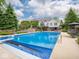 Lovely in-ground swimming pool in the backyard with lush trees and landscaping offering a private retreat at 5784 N 600 E, Greenfield, IN 46140