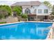 Backyard swimming pool with steps leading to the raised deck and home featuring solar panels at 5784 N 600 E, Greenfield, IN 46140