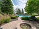 Beautiful inground pool surrounded by lush landscaping and mature trees at 5784 N 600 E, Greenfield, IN 46140