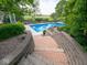 View of an in-ground pool from stone steps and retaining wall at 5784 N 600 E, Greenfield, IN 46140