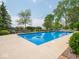 Backyard pool features lush green landscape with trees, exterior grill, and umbrella-covered seating at 5784 N 600 E, Greenfield, IN 46140