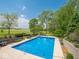 Beautiful pool with string lights and manicured landscaping, perfect for summertime enjoyment at 5784 N 600 E, Greenfield, IN 46140