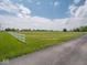 Expansive yard featuring a lush lawn and a white fence, offering privacy and curb appeal at 5784 N 600 E, Greenfield, IN 46140