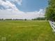 Large, well-maintained yard with a white fence and ample space for gardening or relaxation at 5784 N 600 E, Greenfield, IN 46140