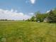 Vast yard featuring a lush lawn and surrounding greenery, offering endless outdoor possibilities at 5784 N 600 E, Greenfield, IN 46140