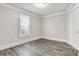 Simple bedroom with wood-look floors and a window at 606 N Colorado Ave, Indianapolis, IN 46201