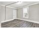Well-lit bedroom with large window and wood-look floors at 606 N Colorado Ave, Indianapolis, IN 46201