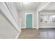 Bright entryway with light gray walls, wood-look floors, and a teal door at 606 N Colorado Ave, Indianapolis, IN 46201