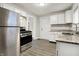 Updated kitchen with stainless steel appliances and granite countertops at 606 N Colorado Ave, Indianapolis, IN 46201