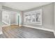 Living room featuring large windows, wood-look floors, and neutral walls at 606 N Colorado Ave, Indianapolis, IN 46201