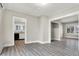 Spacious living area with hardwood floors and views into the kitchen and other rooms at 606 N Colorado Ave, Indianapolis, IN 46201
